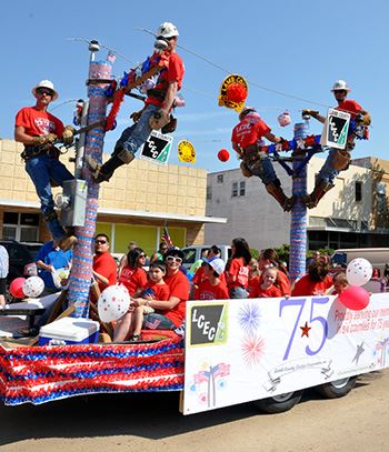People ride on a float during a parade