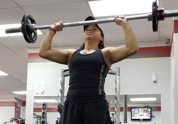 A woman lifts weights