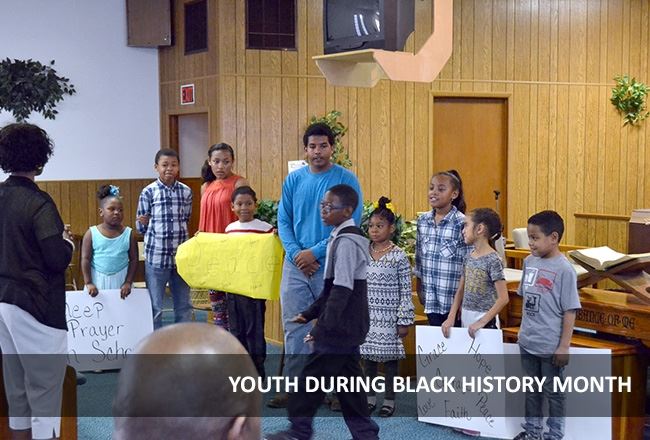 Young people attend an event during Black History Month